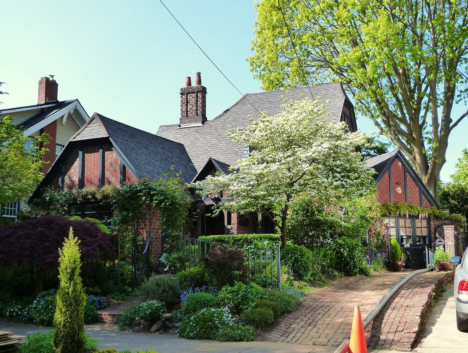 A cleaned cream-brick Southern house with a columned porch in late light